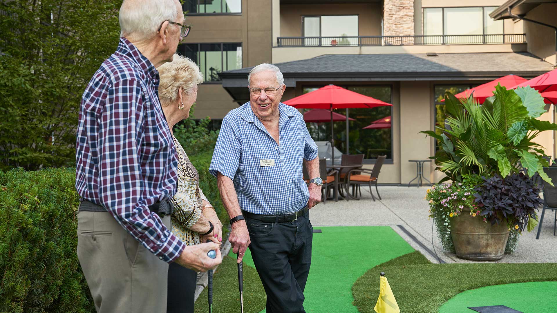 Elderly people playing golf outdoors